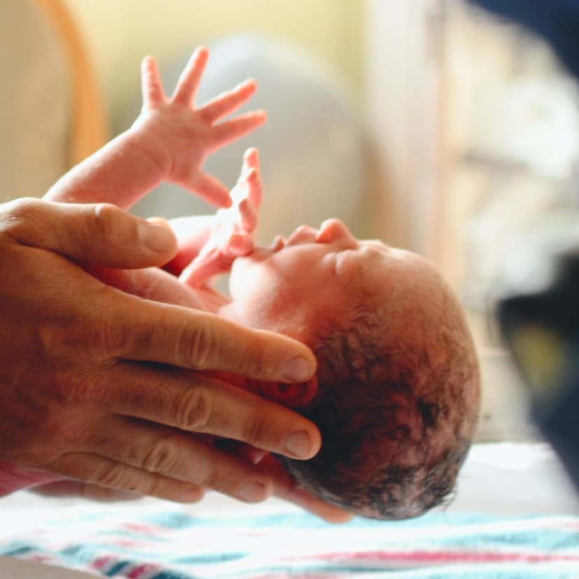 Prof Mark Johnson MRCOG - Consultant Obstetrician with newborn patient - Chelsea Westminster Hospital maternal care specialist